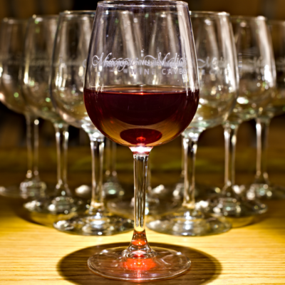 Artistic arrangement of glasses at the bar at Maggie Malik wine caves featuring red wine