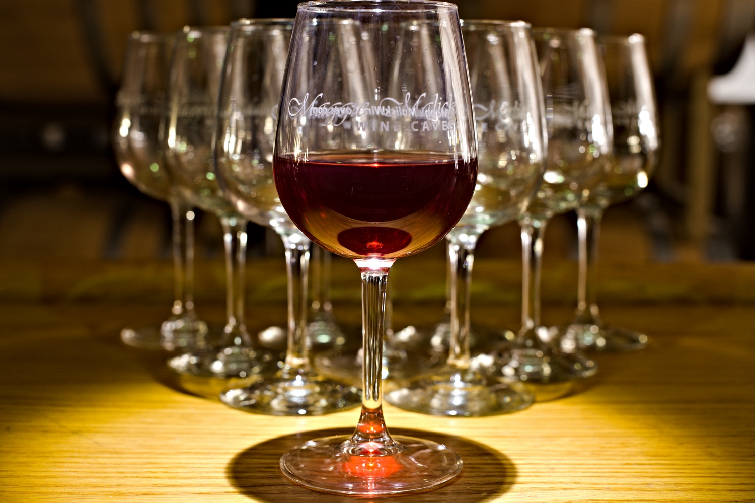 Artistic arrangement of glasses at the bar at Maggie Malik wine caves featuring red wine